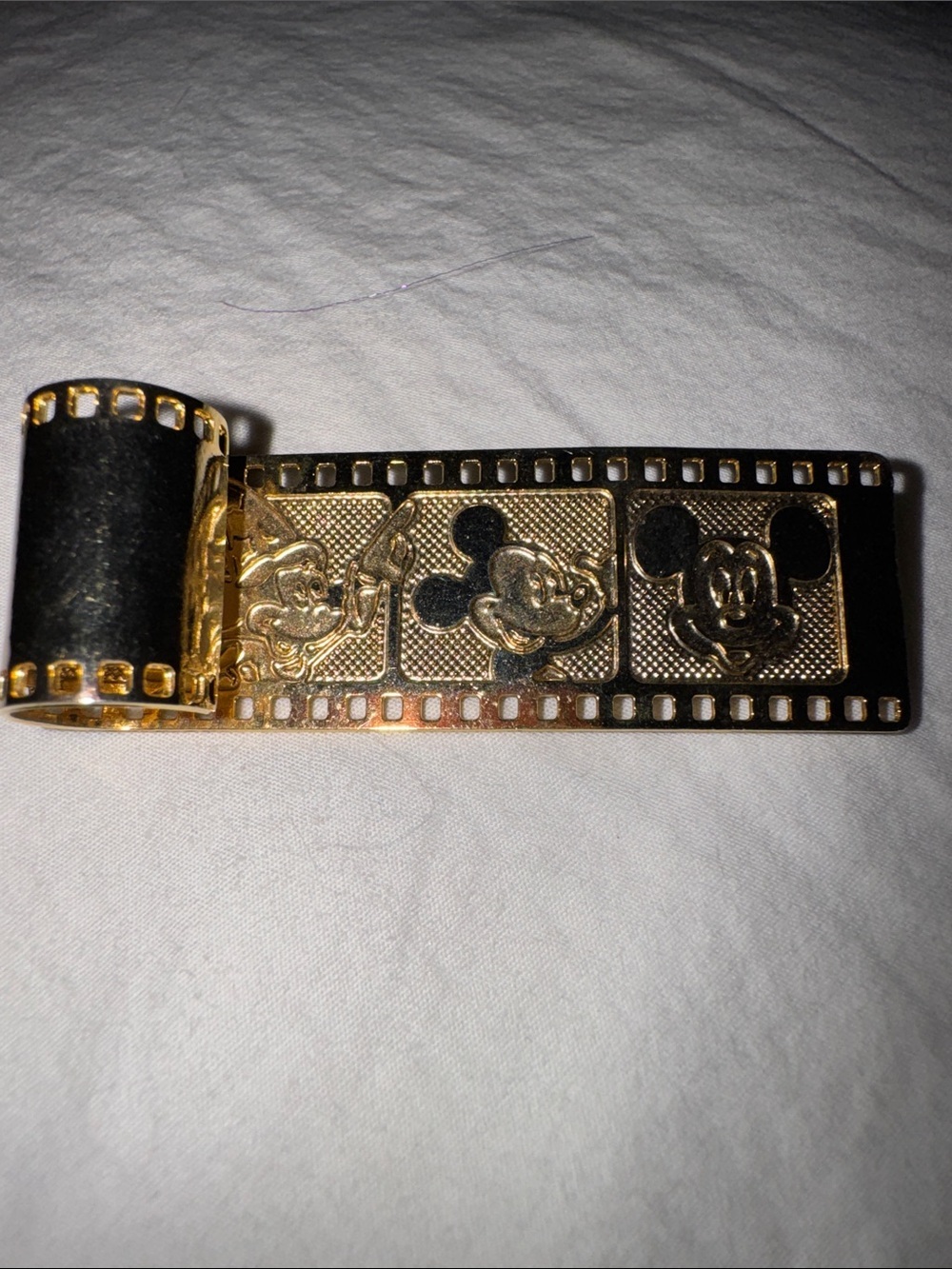 Vintage Collectible Disney gold-tone film strip brooch with layered accents